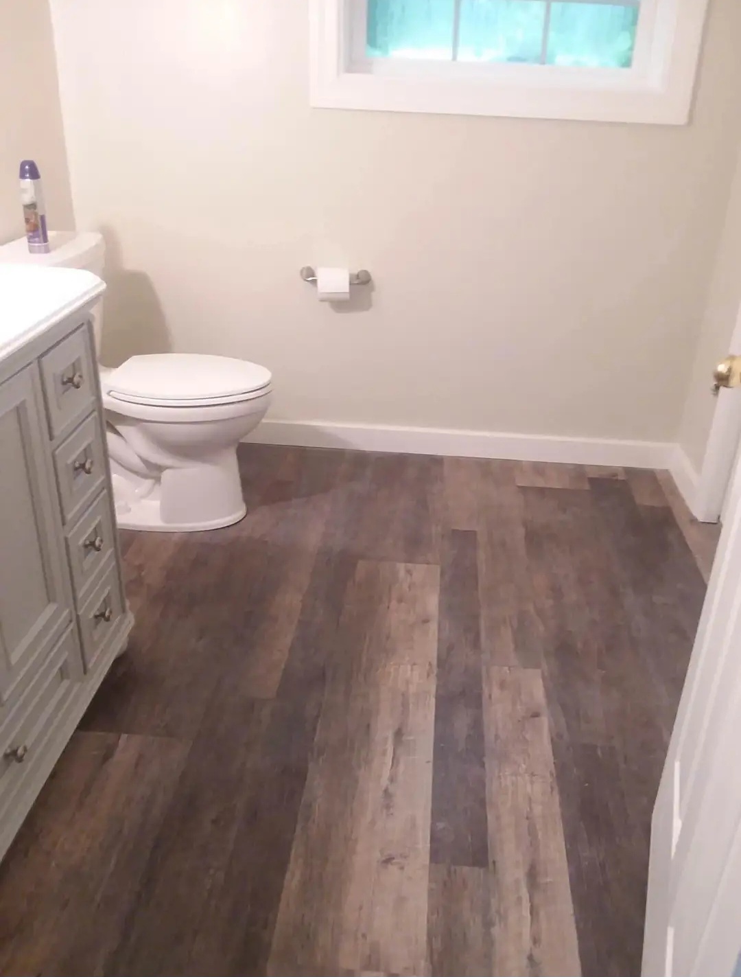 Completed bathroom with new flooring, vanity, and fixtures