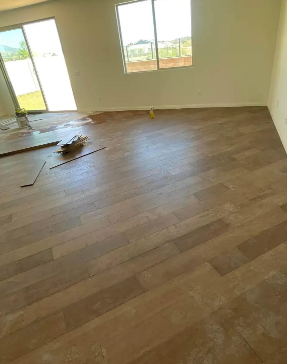 Wood-look plank flooring being installed in a living room