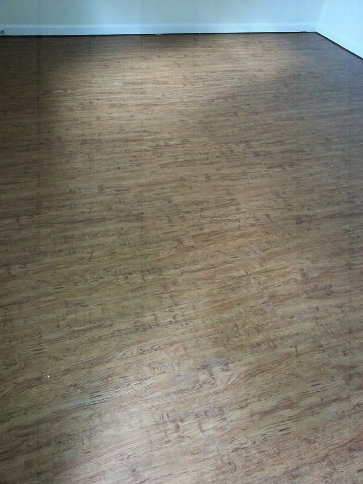 Finished wood-look plank flooring in an empty room